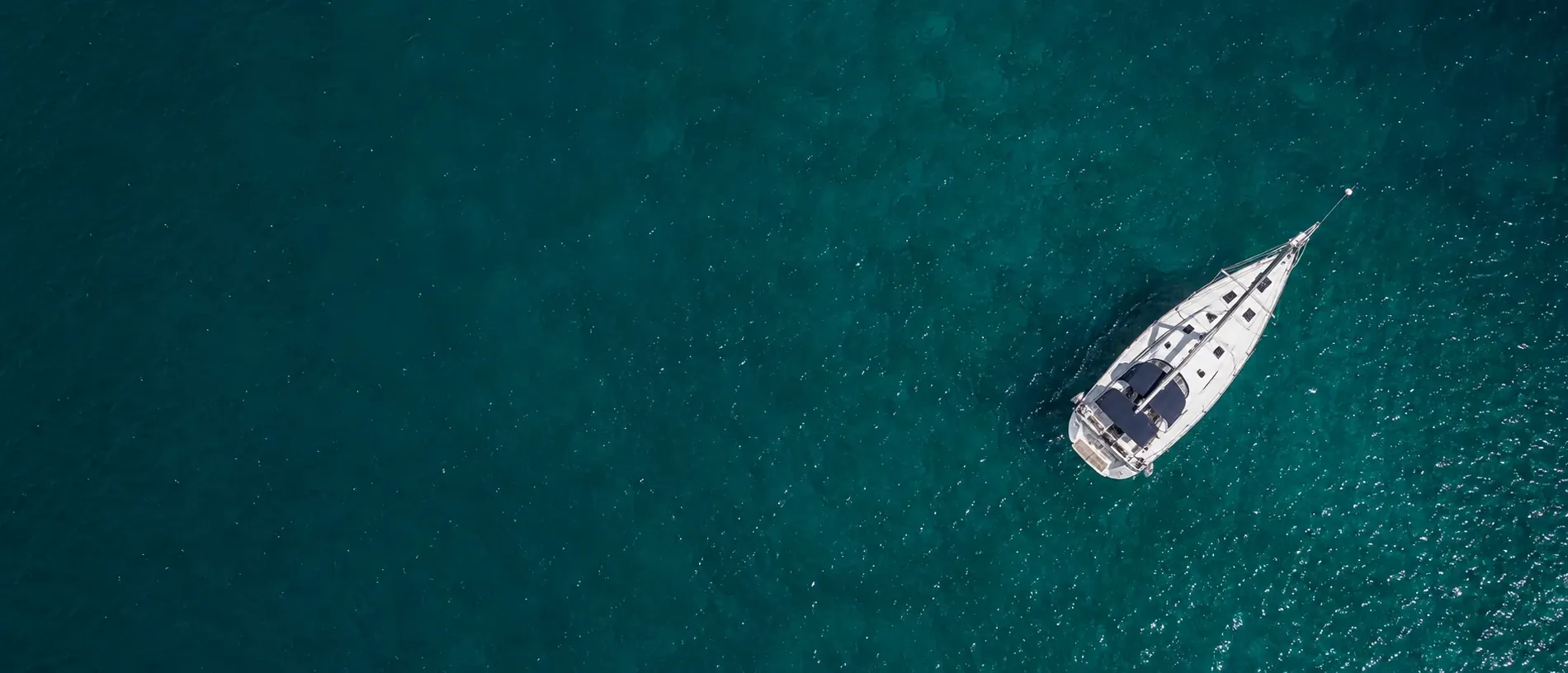 Yacht anchored in clear turquoise water – BioFlow marine plumbing solution